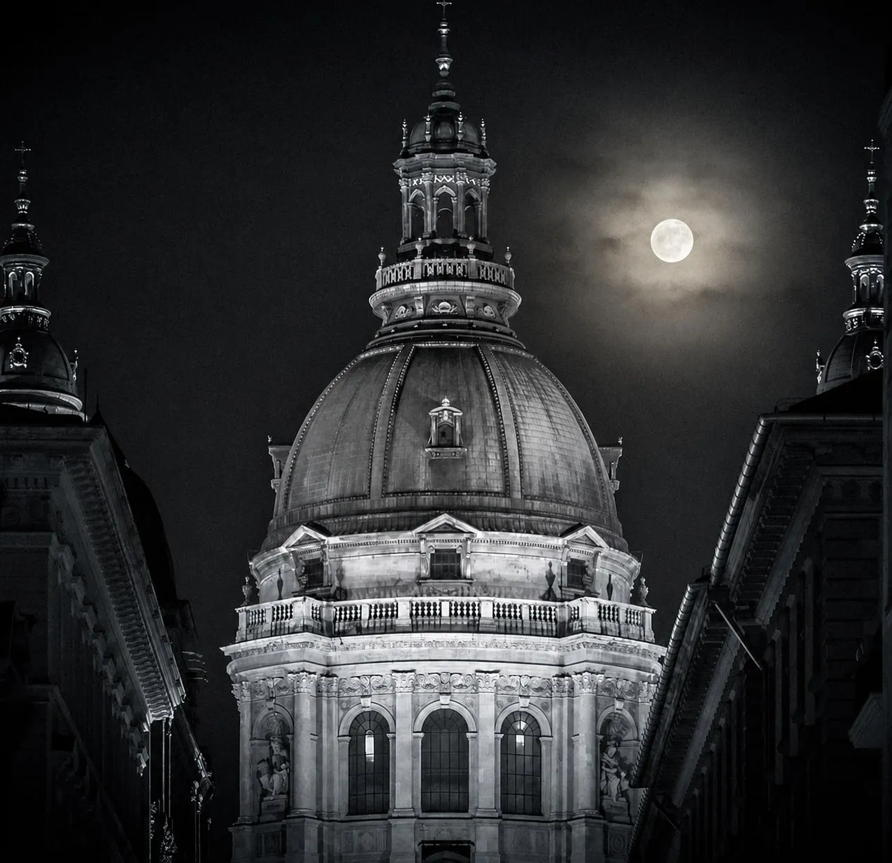 St. Stephen's Basilica, Budapest, under a full moon at night.